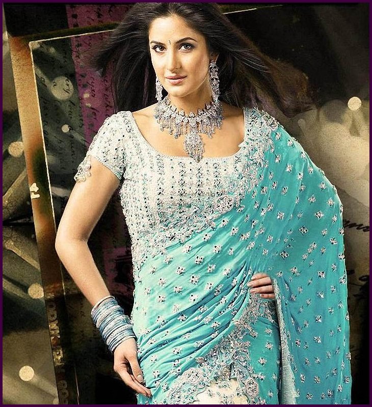 The look of a temptress. A white and blue saree.
